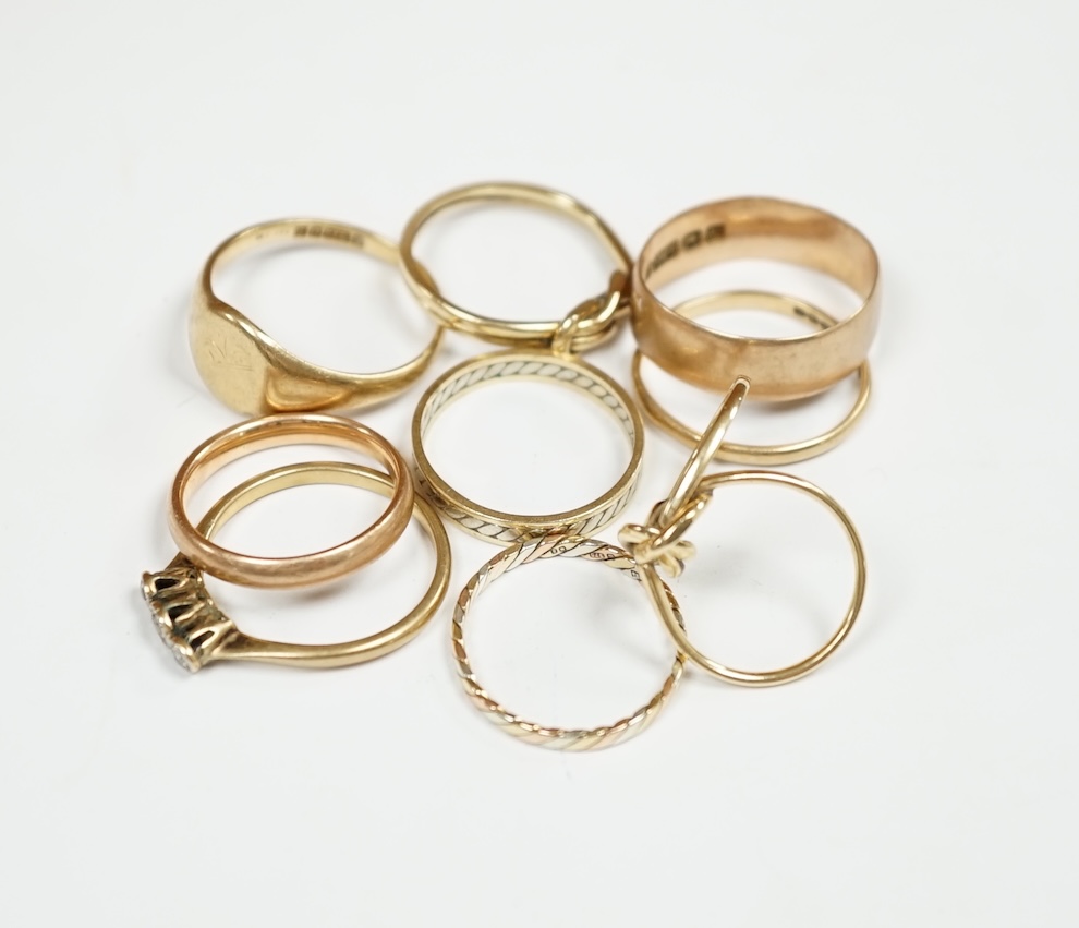 Six assorted 9ct gold bands, including two colour, together with a 9ct gold signet ring, a double band 9ct ring and a 9ct and three stone gem set ring, gross weight 18.8 grams. Condition - poor to fair